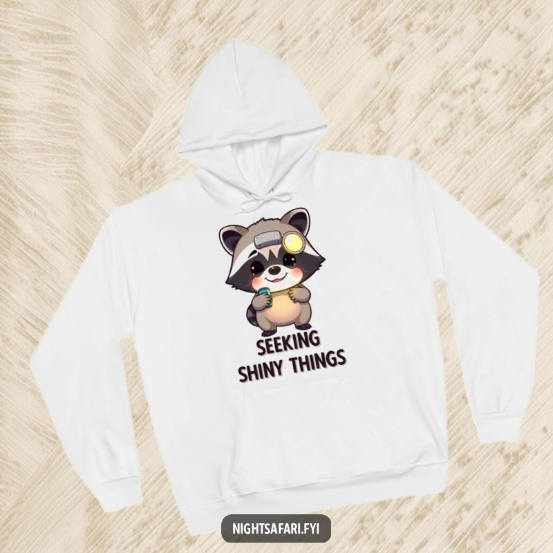 Funny cheerful raccoon wearing a headlamp rummaging, featured on a cozy hoodie for fans of clever critters.