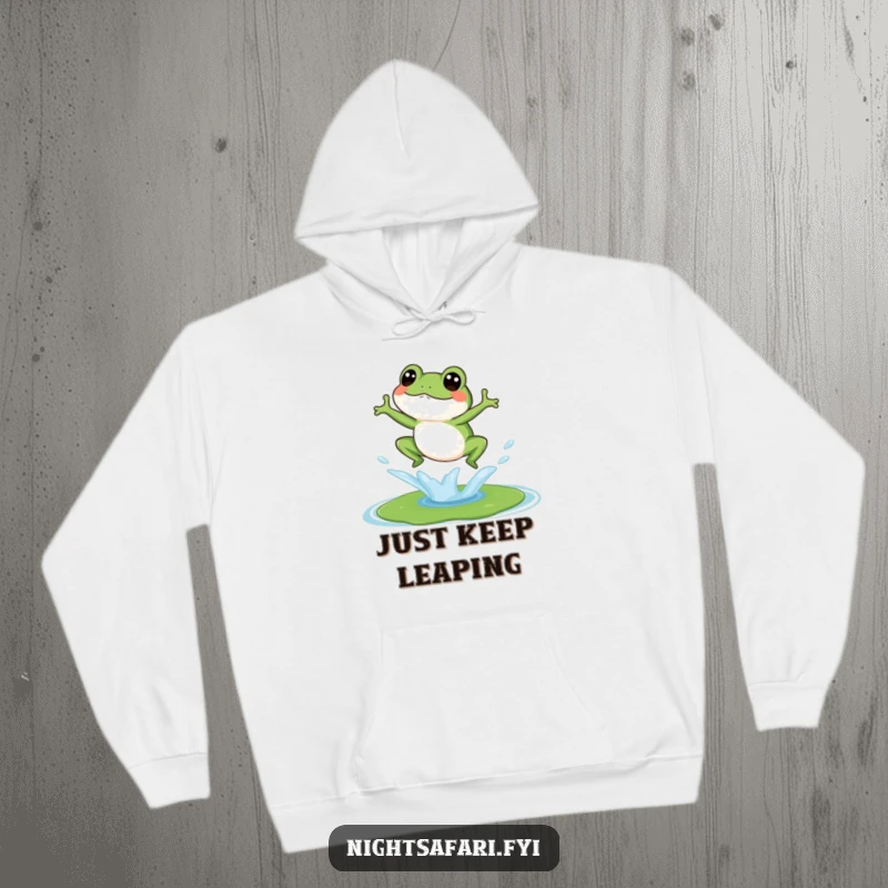 Funny hoodie depicting a happy, giggling frog splashing onto a lily pad, emphasizing a carefree attitude.